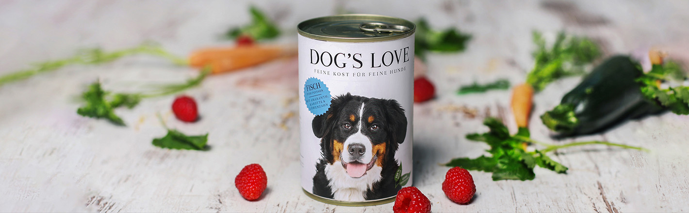 A can of DOG'S LOVE fish surrounded by carrots & raspberries