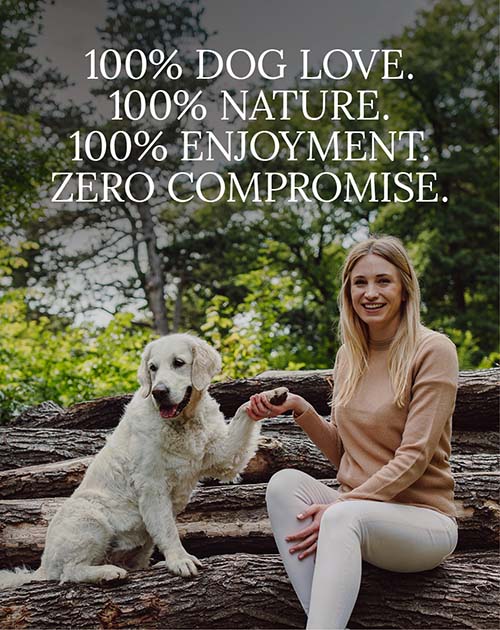 Katharina Miklauz with her dog Nala is sitting on tree trunks